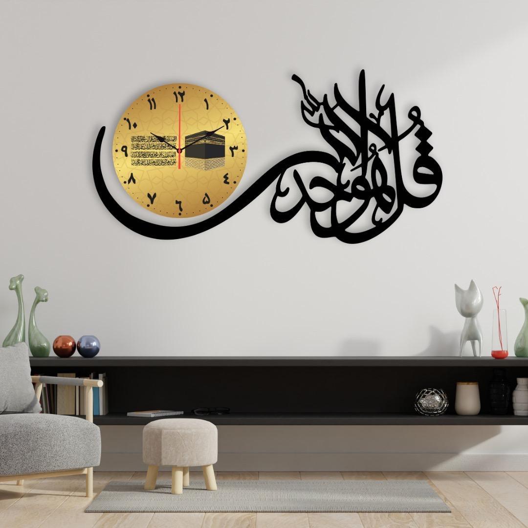 Black and gold Islamic calligraphy wall clock with Kaaba design displayed above a modern sofa, showing product features and details.